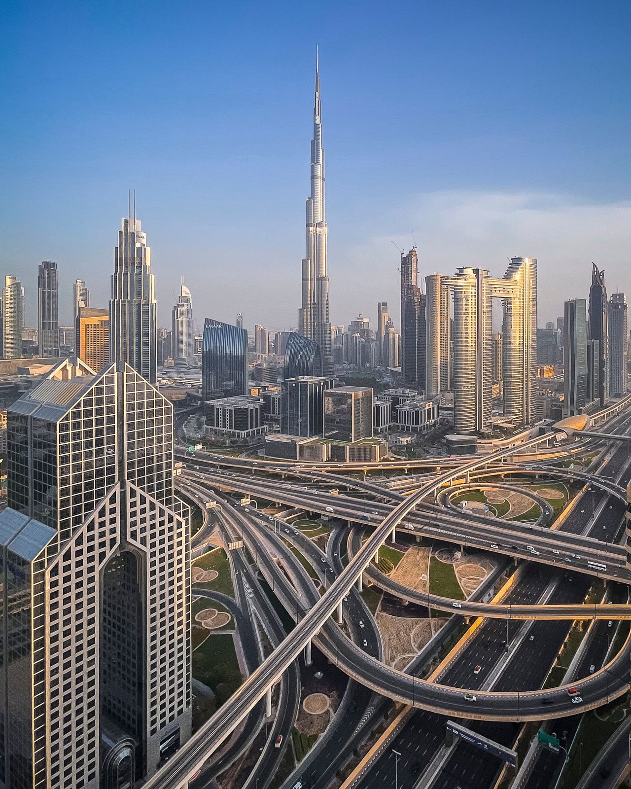 Aerial view of Dubai's skyline and road interchange at sunset